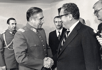Chilean dictator Augusto Pinochet shaking hands with Kissinger in 1976